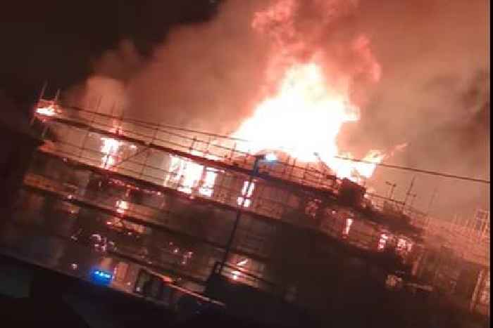 Huge fire rips out at new apartments development as crews tackle flames