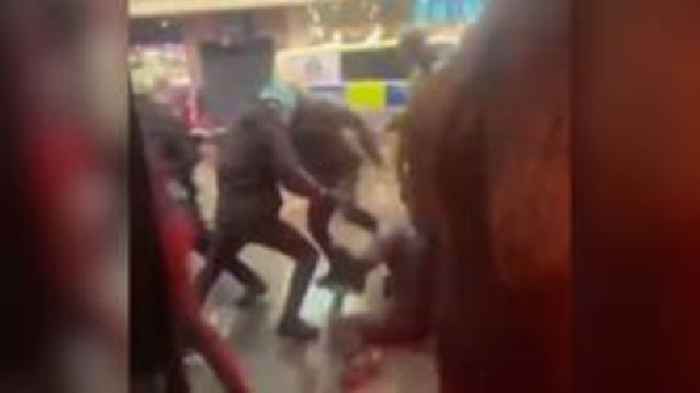 Football fans charge and throw flares near fearful shoppers in pre-match violence