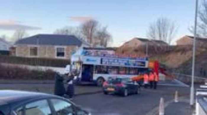 Bus roofless after driving through rail bridge tunnel