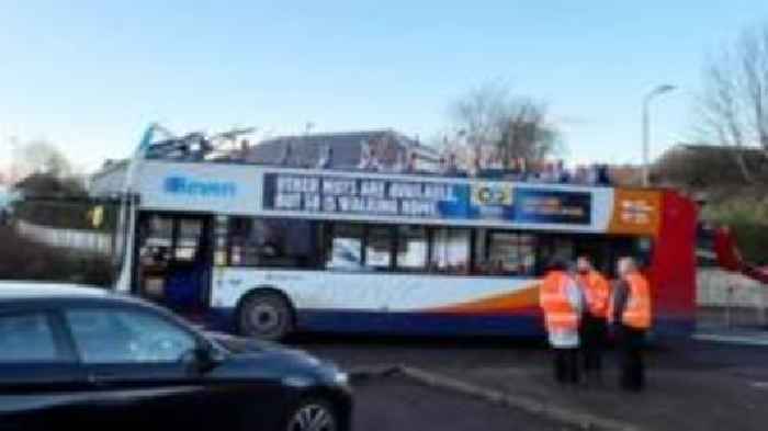 Double decker bus roof torn off in bridge crash