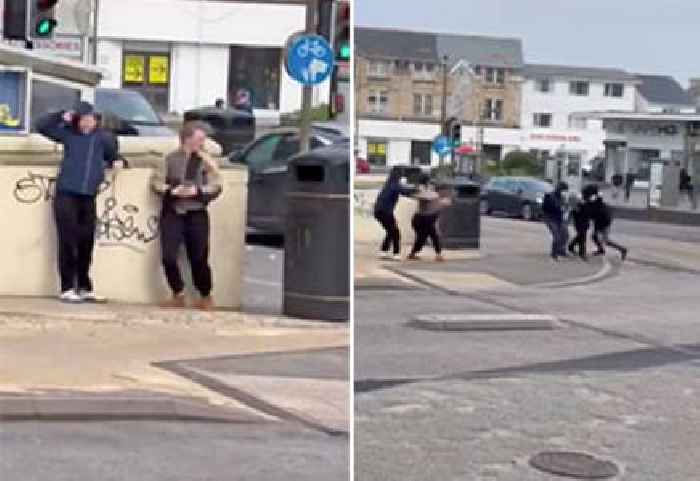 Watch These British Lads Try and Fail to Cross the Street in a Windstorm