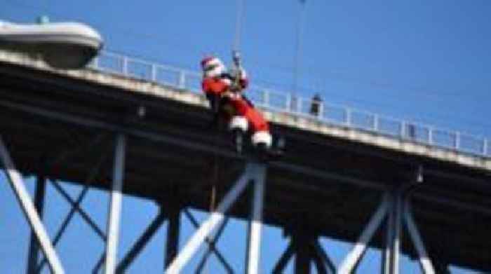 Watch: Abseiling Santa descends from Guatemala bridge to deliver toys