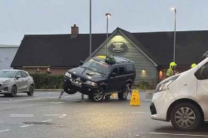 Car rescued by fire service after getting stuck on supermarket bollards