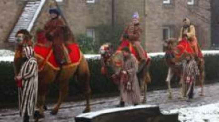 Camels led through grounds of Hereford Cathedral