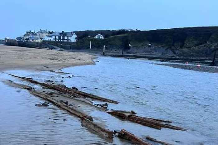 Historic railway remerges on UK beach after sand washed away