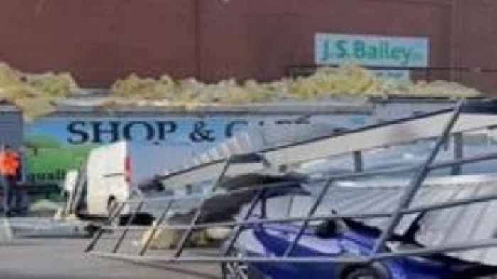 Cars crushed as storm rips roof off building