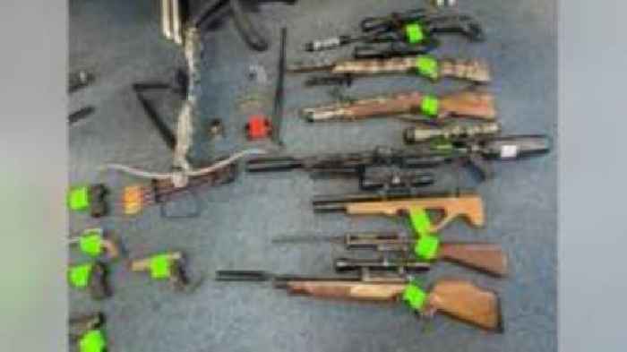 Man admits owning stash of 70 weapons