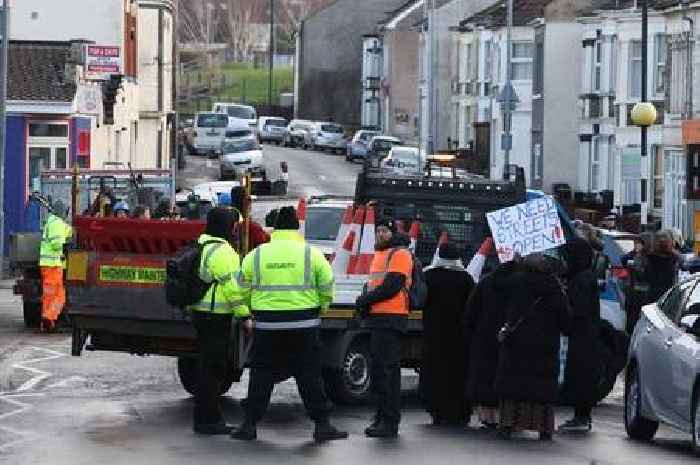 Police called as residents block work to install liveable neighbourhood - live updates