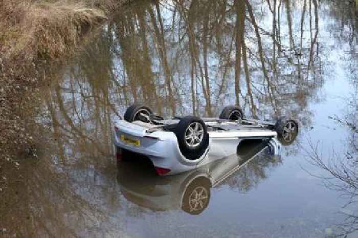 Car left upside-down in canal in Newport