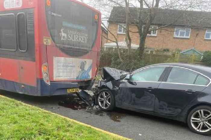 Road in Woking was blocked after car hit bus