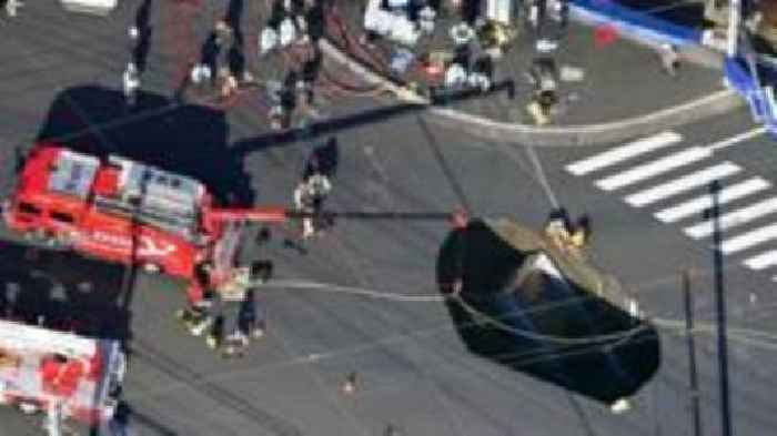 Sinkhole in Japan widens as rescuers try to save truck driver