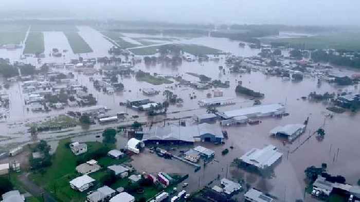 Woman dies and thousands urged to move to higher ground as 'record-breaking rainfall' hits Queensland