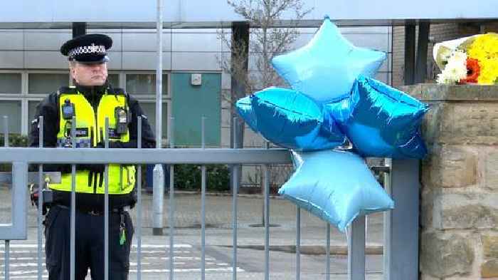 'I can't believe he's gone': Tributes left at school where teen was stabbed to death