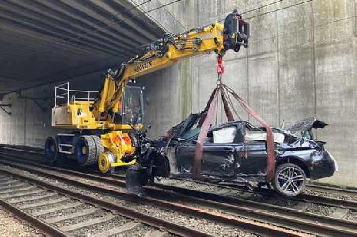 Major train line reopens after BMW plunges 20ft onto tracks