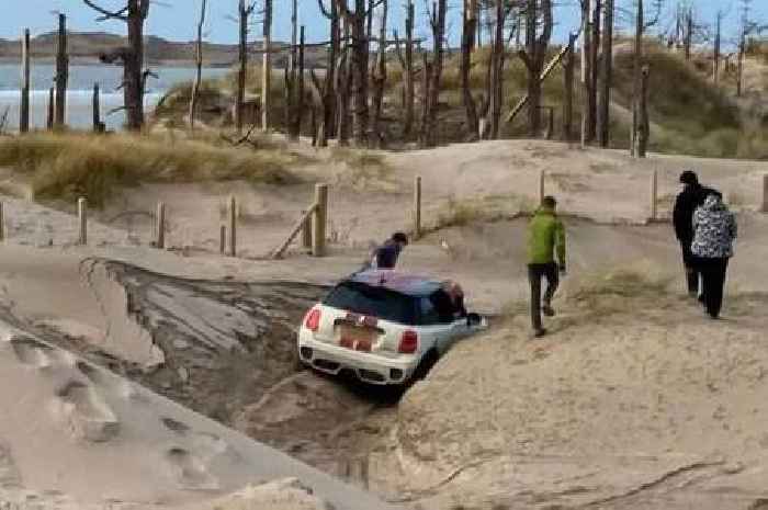 Car gets trapped in giant sand drifts at famous Welsh beach