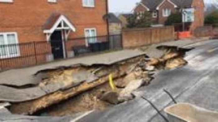 Watch: BBC reporter examines huge sinkhole