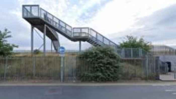 Woman raped on footbridge by dog walker - police