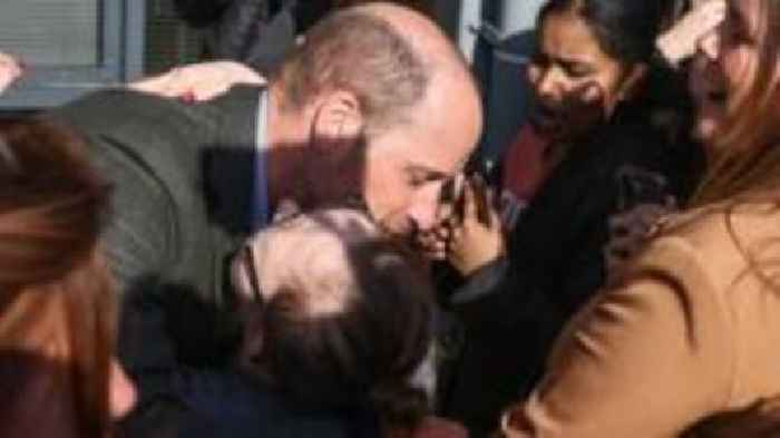 Prince William hugs student on visit to college