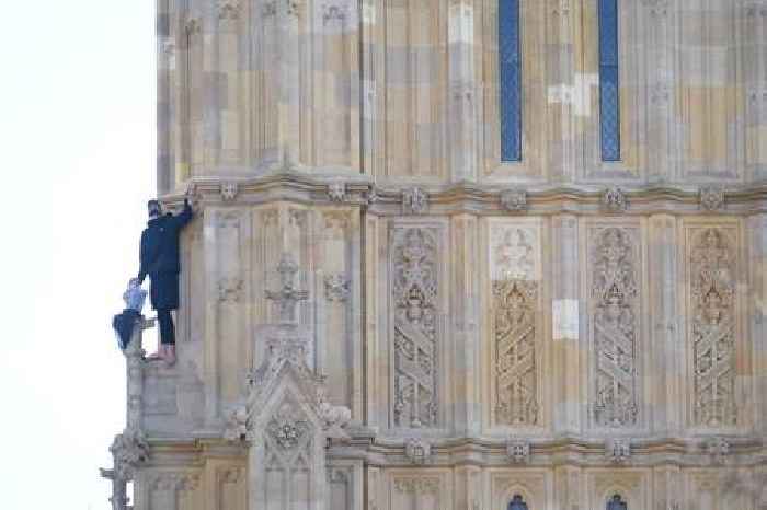 Man climbs Houses of Parliament holding Palestinian flag