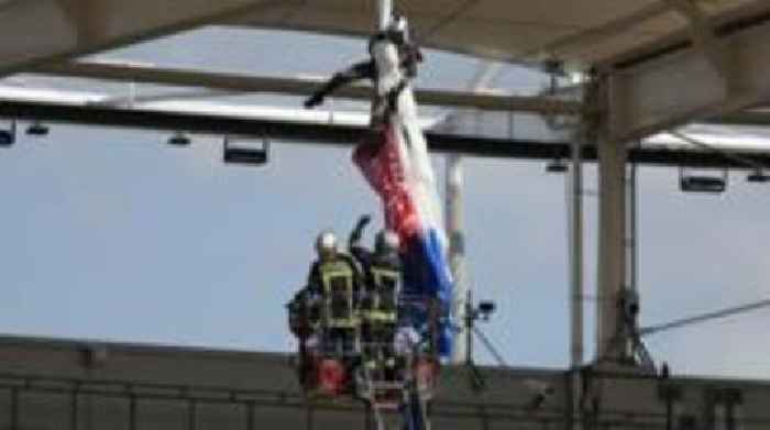 Sale game delayed as parachutist hangs from roof