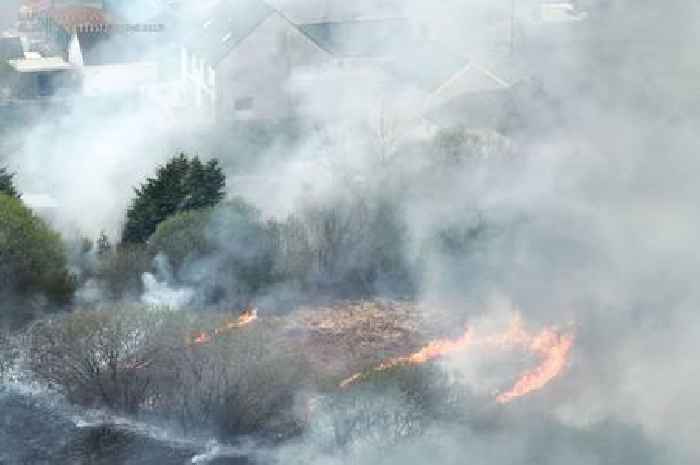 Fire crews battle 'deliberate' fire right near people's homes