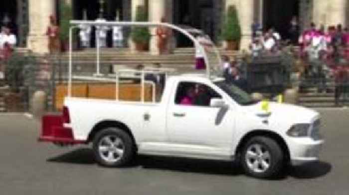 People line the streets as Popemobile carries coffin through Rome