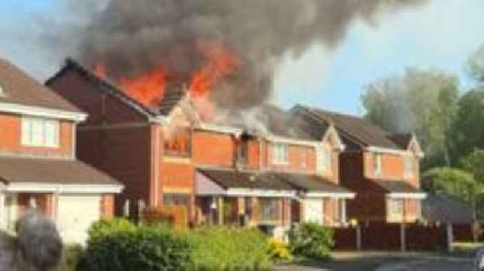 Firefighters tackle blaze spread across two houses