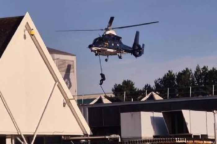 Building close to Tesco stormed by masked figures who drop from helicopters