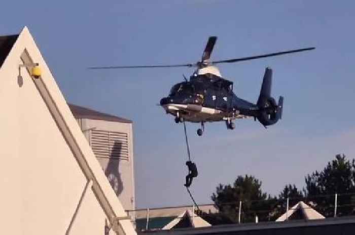 Masked figures drop from helicopters and storm building near Tesco leaving shoppers stunned