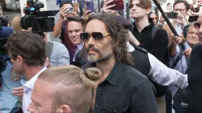 Russell Brand arrives at court after being charged with rape and sexual assault