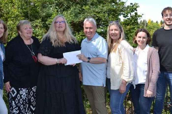 Staff from John Lewis in Blantyre make a donation to local charity LEAP