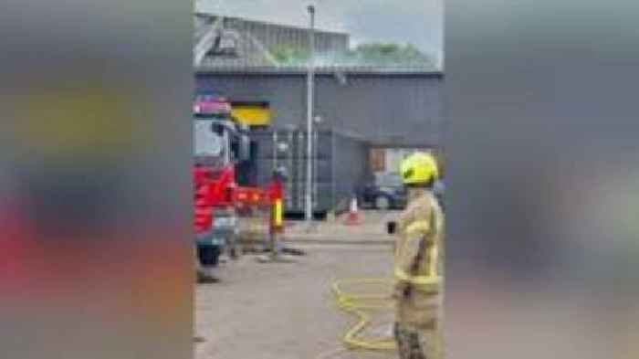 Crews try to stop industrial unit fire spreading