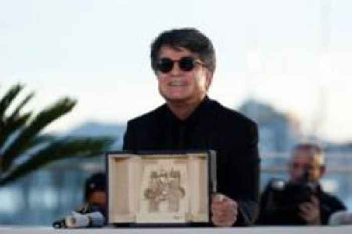 Iran's Palme d'Or-winning director cheered as he arrives home