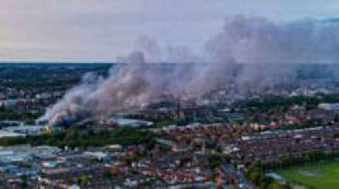 Three arrested after large fire at retail park