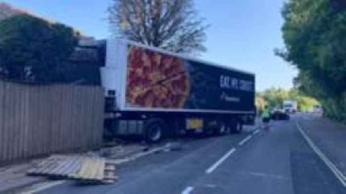 Domino's Pizza lorry crashes through garden fence