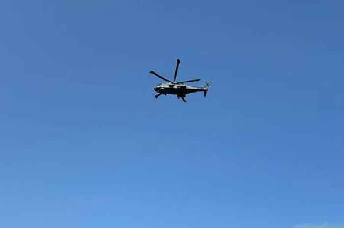 Live: Military helicopter circles seaside town