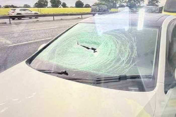 Driver cheats death by inches after piece of metal smashes through windscreen