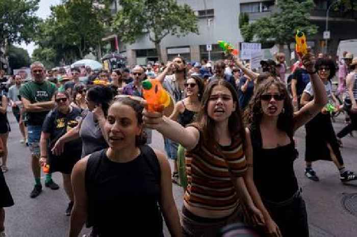 Spanish protesters spray tourists with water guns but visitors unfazed