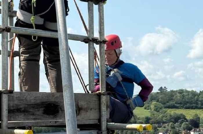 Bishop of Guildford completes 'terrifying' abseil down cathedral tower as more than £10k raised