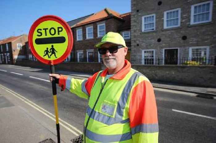 Lollipop man BANNED from giving children 'high fives'