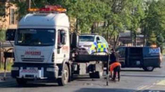 Man in hospital after police car and e-bike crash