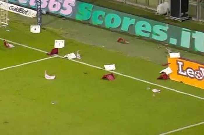 Italian football match abandoned as fans throw chairs and flares onto the pitch