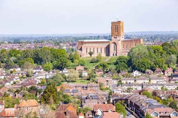 What is Surrey's unofficial 'capital city'? Could it be Guildford, Woking, Reigate, or somewhere else altogether