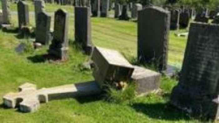 Vandals damage 40 headstones and burn crucifix at cemetery