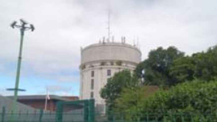 Murder charge as man found dead near water tower