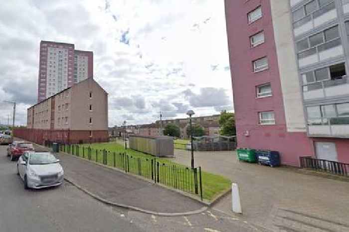 Woman arrested after man's body found at Glasgow flats