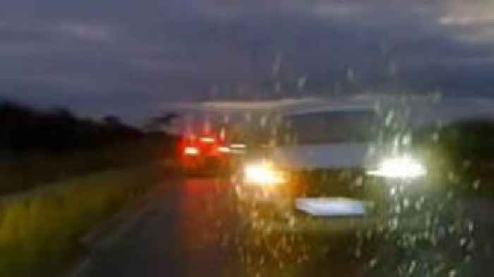 Watch: Careless driver swerves into police car's path