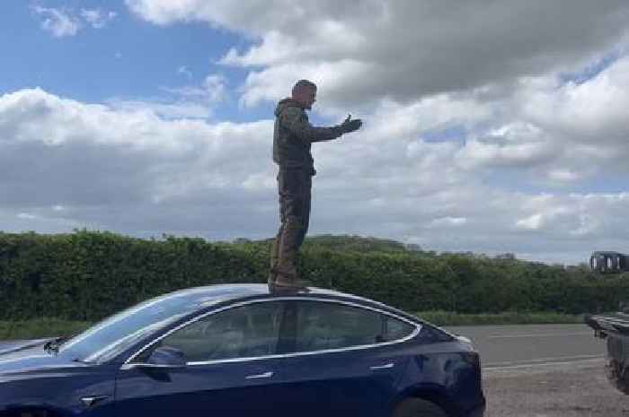 Man fed up with people climbing on tanks jumps up on their Tesla
