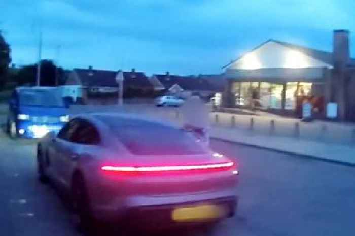 Woman drags police officer down road with Porsche after being pulled over