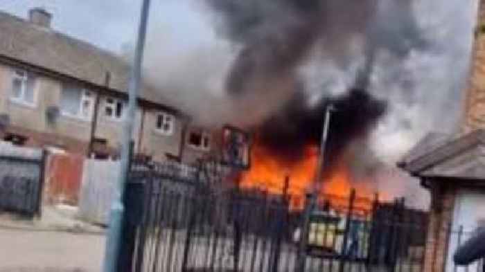 Fire crews tackle house blaze that started in shed
